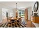 Light filled dining room with hardwood floors, chandelier, and large window at 12160 Oak Hollow Way, Alpharetta, GA 30005