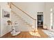 Bright entryway features hardwood floors and elegant staircase with white risers at 12160 Oak Hollow Way, Alpharetta, GA 30005