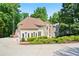 Charming traditional home featuring a manicured front lawn and mature trees at 12160 Oak Hollow Way, Alpharetta, GA 30005