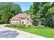 Charming traditional home featuring a manicured front lawn and mature trees at 12160 Oak Hollow Way, Alpharetta, GA 30005