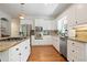 Bright kitchen with stainless steel appliances, granite countertops, and hardwood flooring at 12160 Oak Hollow Way, Alpharetta, GA 30005