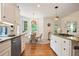 Bright eat-in kitchen with stainless appliances, granite countertops, and hardwood floors at 12160 Oak Hollow Way, Alpharetta, GA 30005