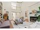 Open living room with fireplace, large windows, and vaulted ceilings at 12160 Oak Hollow Way, Alpharetta, GA 30005