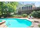 Resort style pool and lounge chairs with mature trees and beautiful home at 12160 Oak Hollow Way, Alpharetta, GA 30005