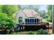 Charming home featuring a deck, screened porch, and beautiful backyard landscaping at 12160 Oak Hollow Way, Alpharetta, GA 30005