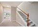 Carpeted staircase with white wood railings and natural wood banister in neutral decor at 12160 Oak Hollow Way, Alpharetta, GA 30005