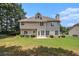 Exterior shot of the home's back featuring multi-pane windows and a lush, green lawn at 1900 Green Oak Cir, Lawrenceville, GA 30043