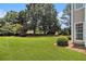 Spacious backyard featuring a large lawn and mature trees offering ample shade and privacy at 1900 Green Oak Cir, Lawrenceville, GA 30043