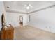 Bedroom with tray ceiling, and ensuite bath, carpeting, bright window and decorative molding at 1900 Green Oak Cir, Lawrenceville, GA 30043