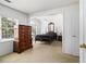 Well-lit bedroom with a four-poster bed, large window and neutral carpet at 1900 Green Oak Cir, Lawrenceville, GA 30043