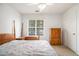 Bright bedroom featuring a vintage wooden bed frame and neutral walls at 1900 Green Oak Cir, Lawrenceville, GA 30043