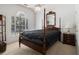 Spacious bedroom with four-poster bed, neutral carpet, and natural light at 1900 Green Oak Cir, Lawrenceville, GA 30043