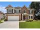 Charming two-story home with a well-maintained lawn and traditional architectural details at 1900 Green Oak Cir, Lawrenceville, GA 30043