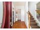 Inviting foyer with hardwood floors and a staircase featuring patterned carpet at 1900 Green Oak Cir, Lawrenceville, GA 30043