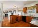 Traditional kitchen with wooden cabinets, stainless steel appliances, and hardwood floors open to a living space at 1900 Green Oak Cir, Lawrenceville, GA 30043
