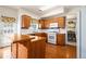 Functional kitchen with wooden cabinets, white appliances, and a breakfast bar at 1900 Green Oak Cir, Lawrenceville, GA 30043