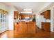 Functional kitchen with wooden cabinets, white appliances, and a breakfast bar at 1900 Green Oak Cir, Lawrenceville, GA 30043