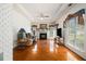 Bright living room with hardwood floors, fireplace, large window, and decorative drapes and crown molding at 1900 Green Oak Cir, Lawrenceville, GA 30043