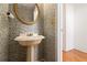 Quaint powder room features a pedestal sink, decorative wallpaper, and classic charm at 1900 Green Oak Cir, Lawrenceville, GA 30043