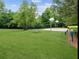 Community basketball court with hoops, benches, and a grassy field for outdoor activities at 219 Sleepy Way, Canton, GA 30114