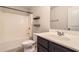 Well-lit bathroom with a shower and tub combination, floating shelves, and dark wood vanity at 219 Sleepy Way, Canton, GA 30114
