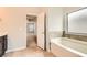 Bathroom with a soaking tub and tiled walls located off the main bedroom at 219 Sleepy Way, Canton, GA 30114