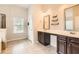 Bathroom features a double vanity, a separate glass shower, and a soaking tub at 219 Sleepy Way, Canton, GA 30114