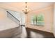 Dining room with dark hardwood floors, wainscoting, and a modern chandelier at 219 Sleepy Way, Canton, GA 30114