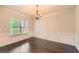 Spacious dining room featuring hardwood floors, wainscoting, and a large window for natural light at 219 Sleepy Way, Canton, GA 30114