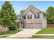 Charming two-story home with a brick facade, well-maintained lawn, and a two-car garage at 219 Sleepy Way, Canton, GA 30114