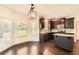 Open kitchen featuring dark wood cabinets, granite countertops, and stainless steel appliances at 219 Sleepy Way, Canton, GA 30114