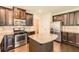 Modern kitchen with dark wood cabinets, stainless steel appliances, and a granite-topped island at 219 Sleepy Way, Canton, GA 30114