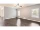 Bright and airy living room featuring hardwood floors and large windows for abundant natural light at 219 Sleepy Way, Canton, GA 30114