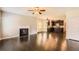 Open-concept living room with a fireplace, dark hardwood floors, and a view of the kitchen at 219 Sleepy Way, Canton, GA 30114