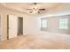 A main bedroom with tray ceiling, ceiling fan, and multiple windows at 219 Sleepy Way, Canton, GA 30114