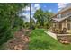Large backyard with a covered patio, green lawn, and mature trees at 2720 Stillwater Lake Ln, Marietta, GA 30066