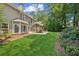 Well-maintained backyard featuring a covered patio, lush lawn, and landscaped garden at 2720 Stillwater Lake Ln, Marietta, GA 30066
