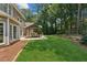 Spacious backyard with a covered patio, green lawn, and mature trees at 2720 Stillwater Lake Ln, Marietta, GA 30066