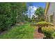Picturesque backyard with mature trees and a covered patio at 2720 Stillwater Lake Ln, Marietta, GA 30066