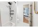 Modern bathroom featuring a sleek shower with rainfall head and a view into the adjacent bedroom at 2720 Stillwater Lake Ln, Marietta, GA 30066