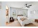 Comfortable bedroom with plush carpet, a ceiling fan, and two windows providing ample natural light at 2720 Stillwater Lake Ln, Marietta, GA 30066