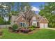 Charming two-story brick home with a well-manicured lawn and mature landscaping at 2720 Stillwater Lake Ln, Marietta, GA 30066