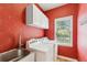 Functional laundry room equipped with modern washer and dryer, overhead cabinets, and a sink for added convenience at 2720 Stillwater Lake Ln, Marietta, GA 30066