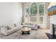 Spacious living room with natural light, comfortable seating, and a cozy fireplace at 2720 Stillwater Lake Ln, Marietta, GA 30066