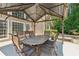 Outdoor dining under a covered patio with seating for six at 2720 Stillwater Lake Ln, Marietta, GA 30066