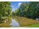 Picturesque pond surrounded by mature trees at 2720 Stillwater Lake Ln, Marietta, GA 30066