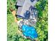 Aerial view of a private home with a backyard pool and patio area surrounded by lush trees at 4393 Cannon Rd, Loganville, GA 30052