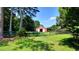 Exterior of a red barn framed by trees and a black fence on a beautiful grassy lot at 4393 Cannon Rd, Loganville, GA 30052