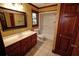 Cozy bathroom with tiled floors, a framed mirror, drawers under the sink, and a shower over tub enclosure at 4393 Cannon Rd, Loganville, GA 30052