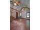 This bedroom showcases wood floors, a vaulted ceiling, and three windows overlooking the outdoors at 4393 Cannon Rd, Loganville, GA 30052